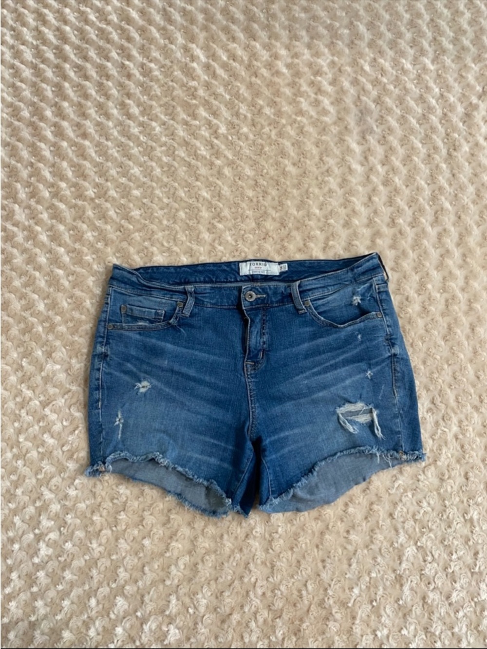Torrid 14 Women distressed denim cut-off shorts in a medium blue wash